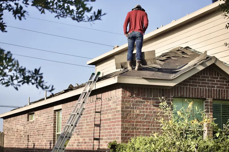 Professional roofer working on a residential roof in White Knoll